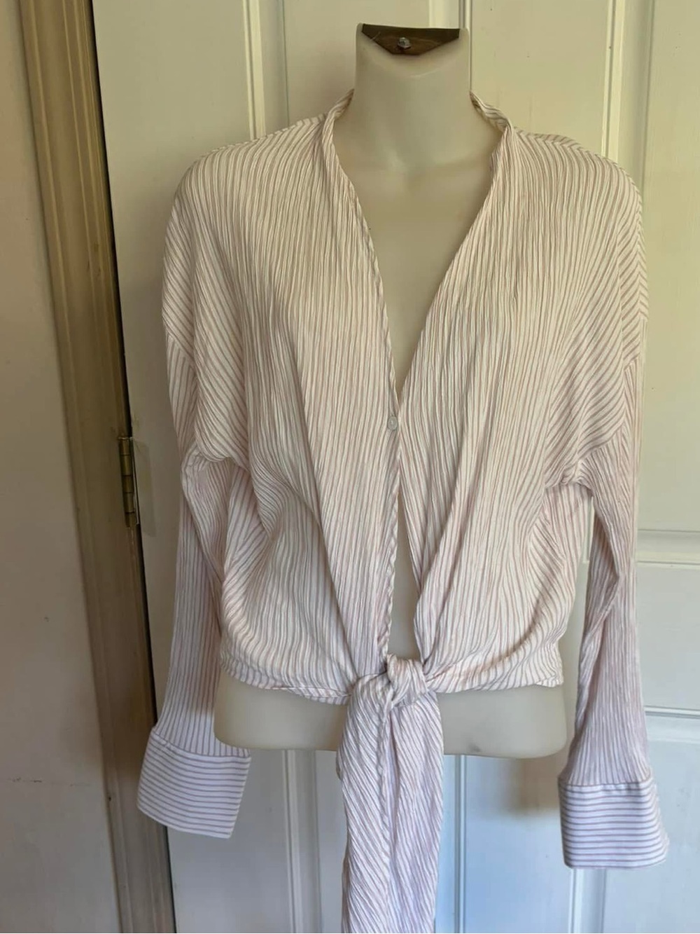 Med Glam white/pink pinstripe 1 button front tie long sleeve cuffed wrap blouse.